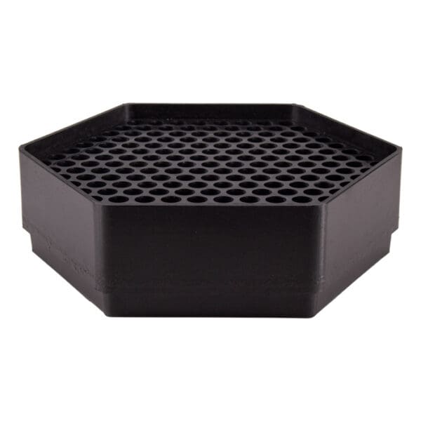 Black hexagonal container with perforated surface.