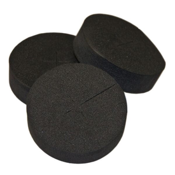 Black foam circular pads stacked together.