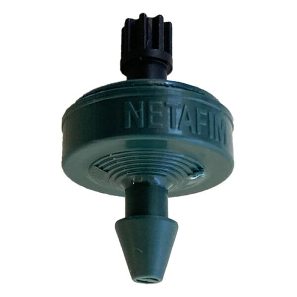 Drip irrigation emitter in green plastic.