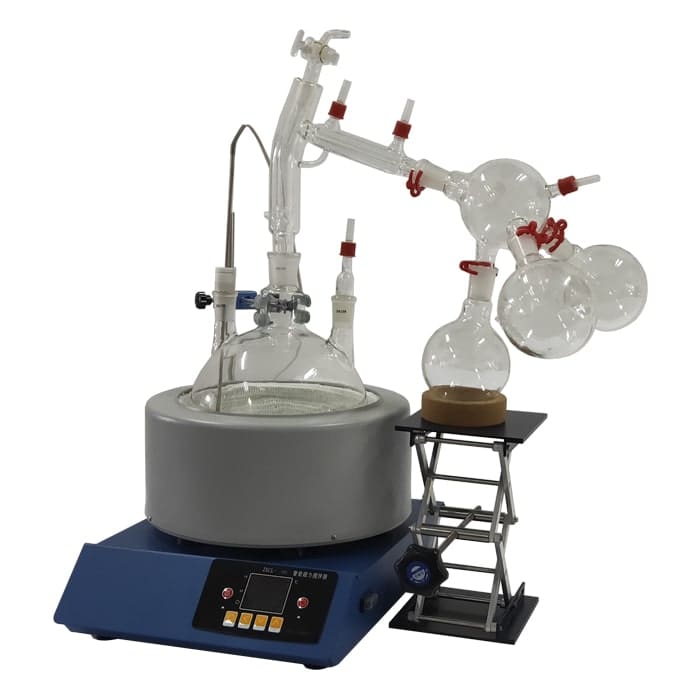 Laboratory distillation equipment on tabletop.