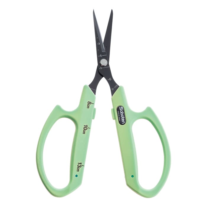 Green scissors with measurement markings.