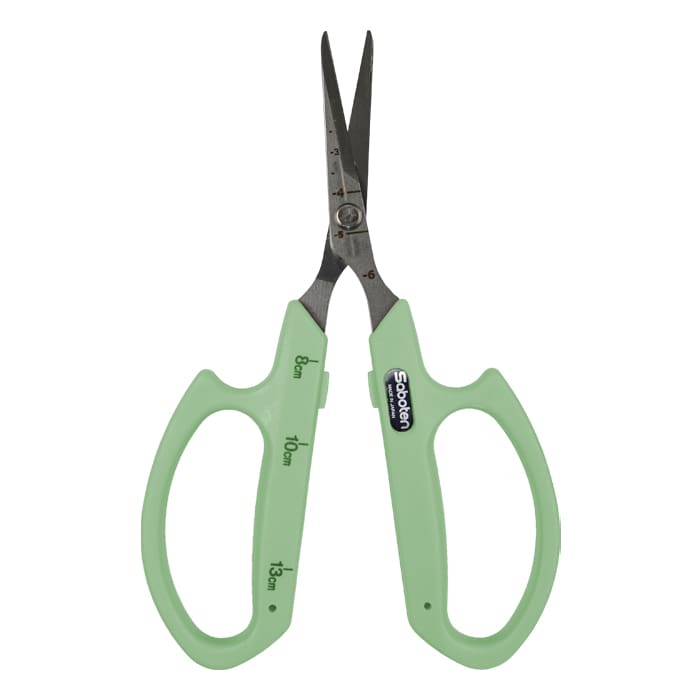 Green scissors with measurement markings.