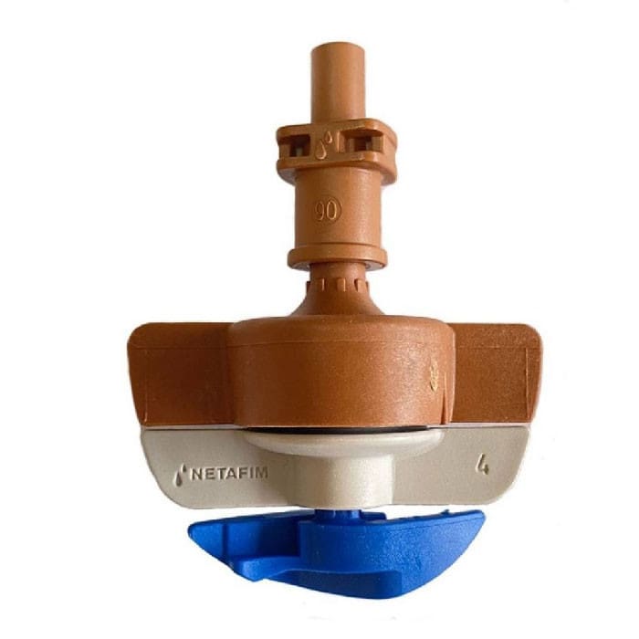 Irrigation emitter with blue nozzle attachment.