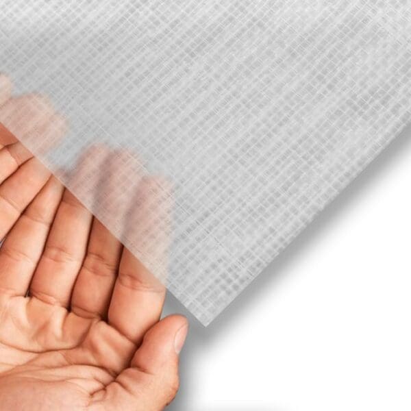 Transparent sheet held above a hand.