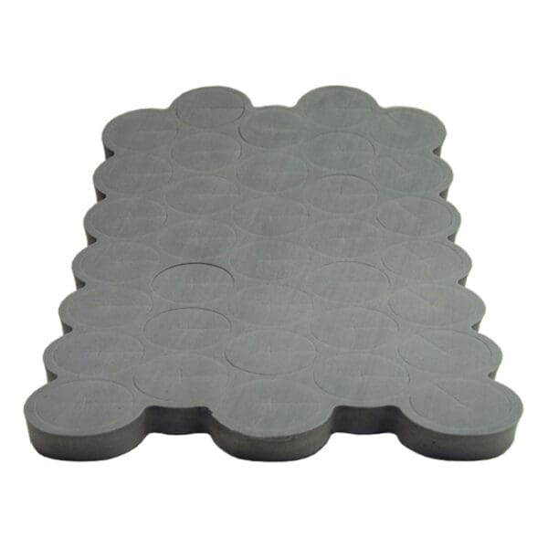 Gray rubber mat with circular patterns.