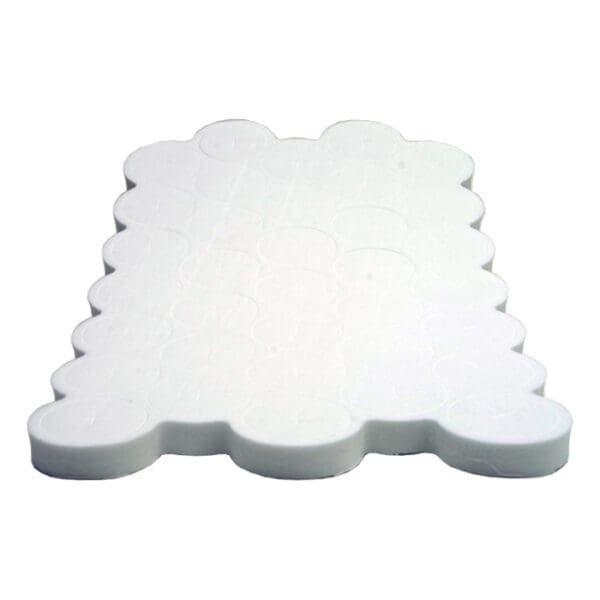 White silicone baking mat with circular molds.