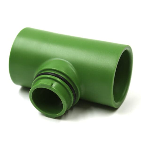 Green plastic pipe fitting on white background.