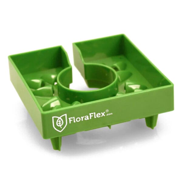 Green plant support tray with circular center.