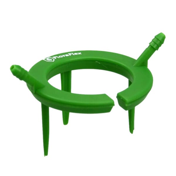 Green plastic plant support ring with spikes.