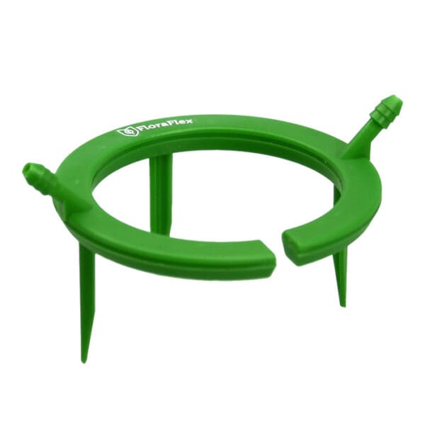 Green plastic plant support ring with spikes.