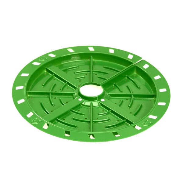 Green circular plate with ventilation holes.