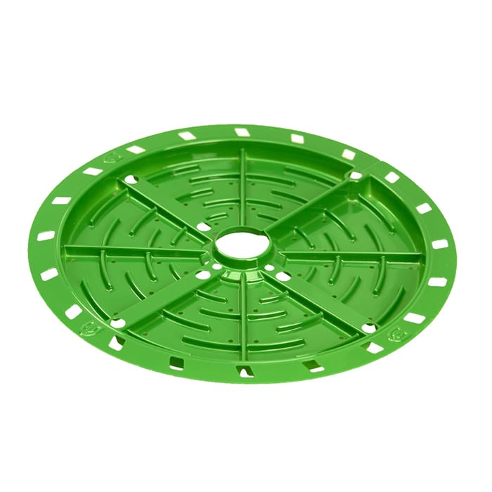 Green circular plastic plate with holes.