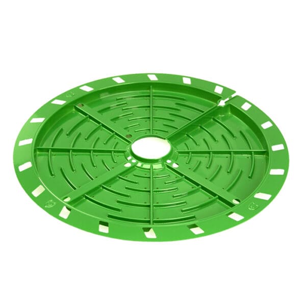 Green circular plastic tray with drainage holes.