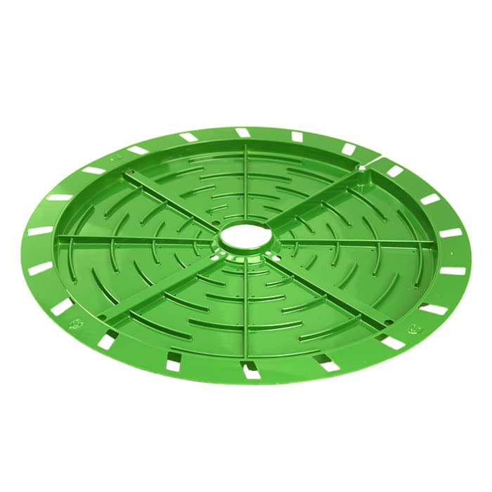 Green circular drainage cover with patterns.